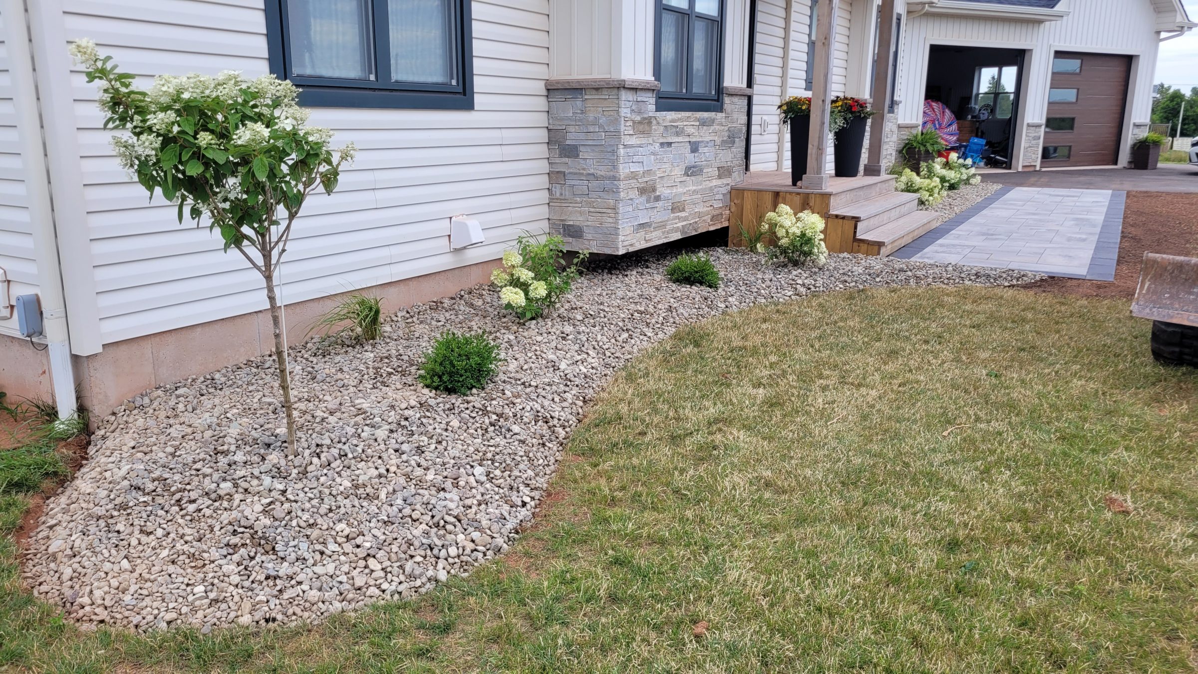 Landscaped garden with stone path and potted plants.