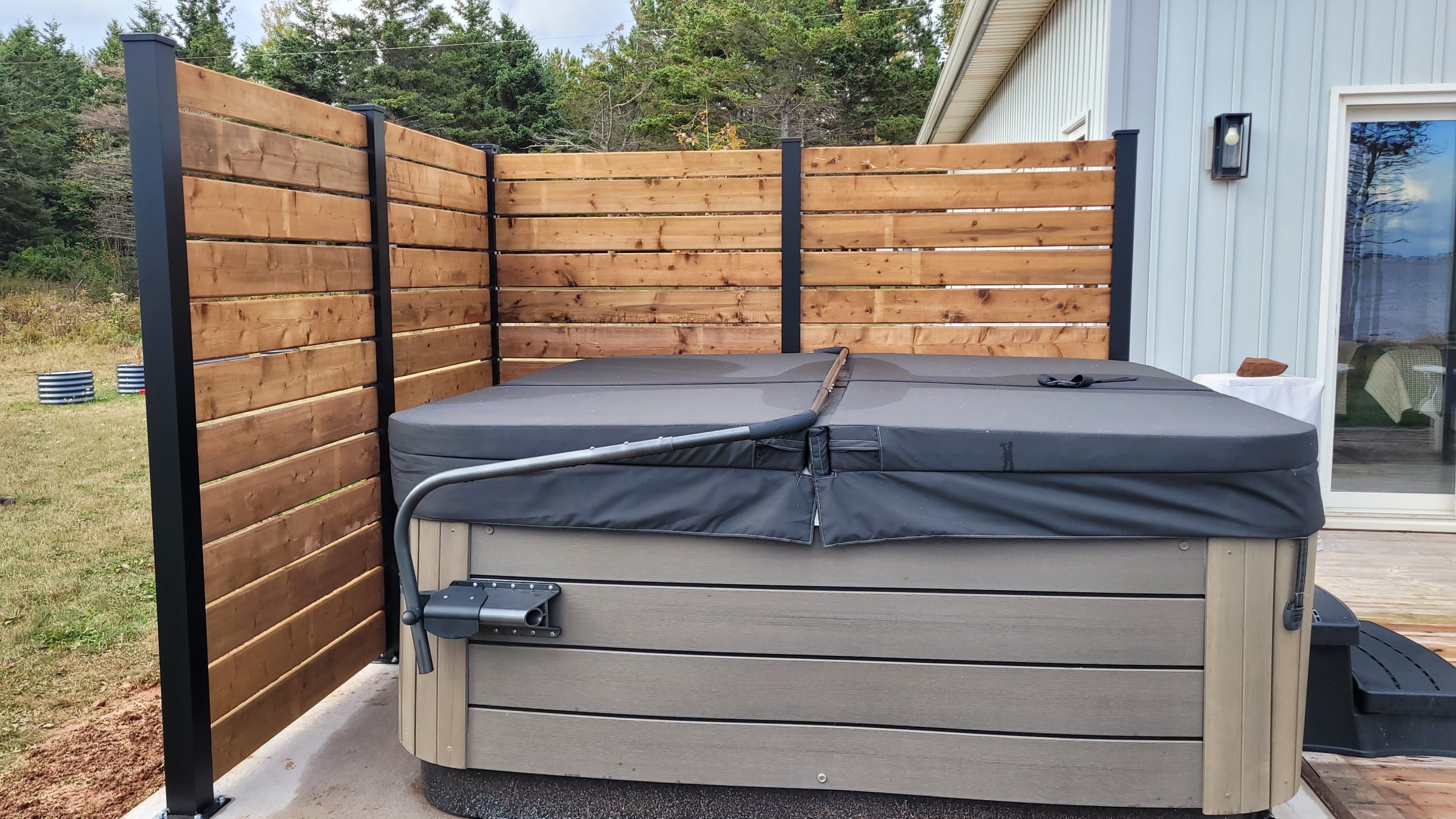 Covered hot tub with wooden privacy fence