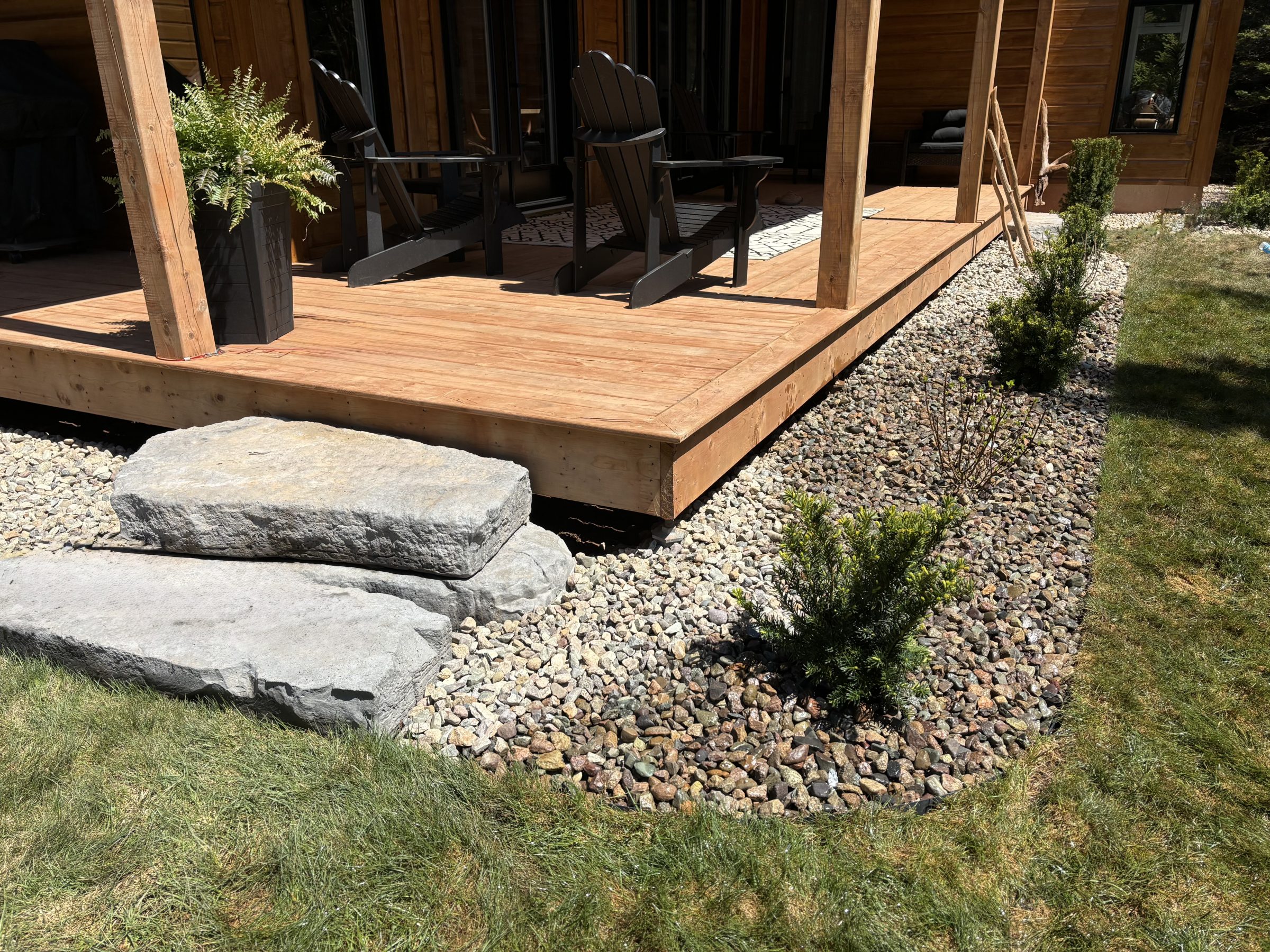 Wooden deck with stone steps and plants
