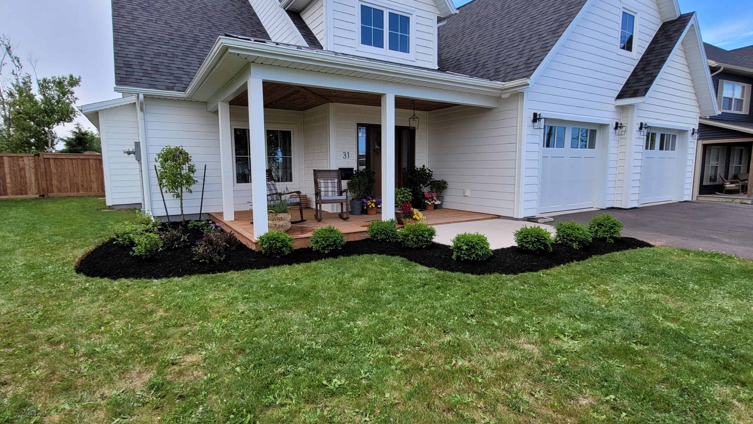 Charming white house with porch and garden.
