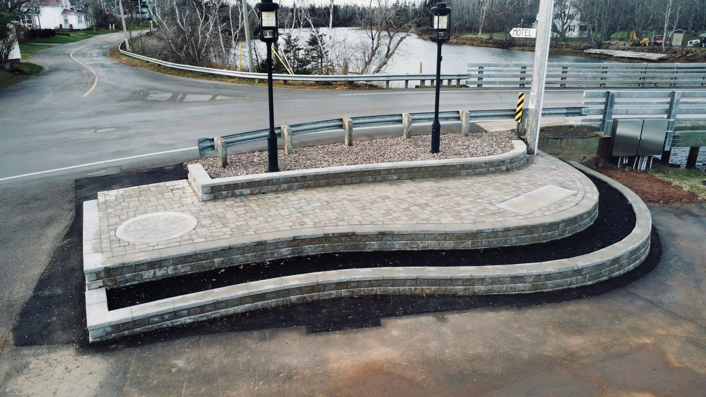 Curved brick seating area near waterfront path.