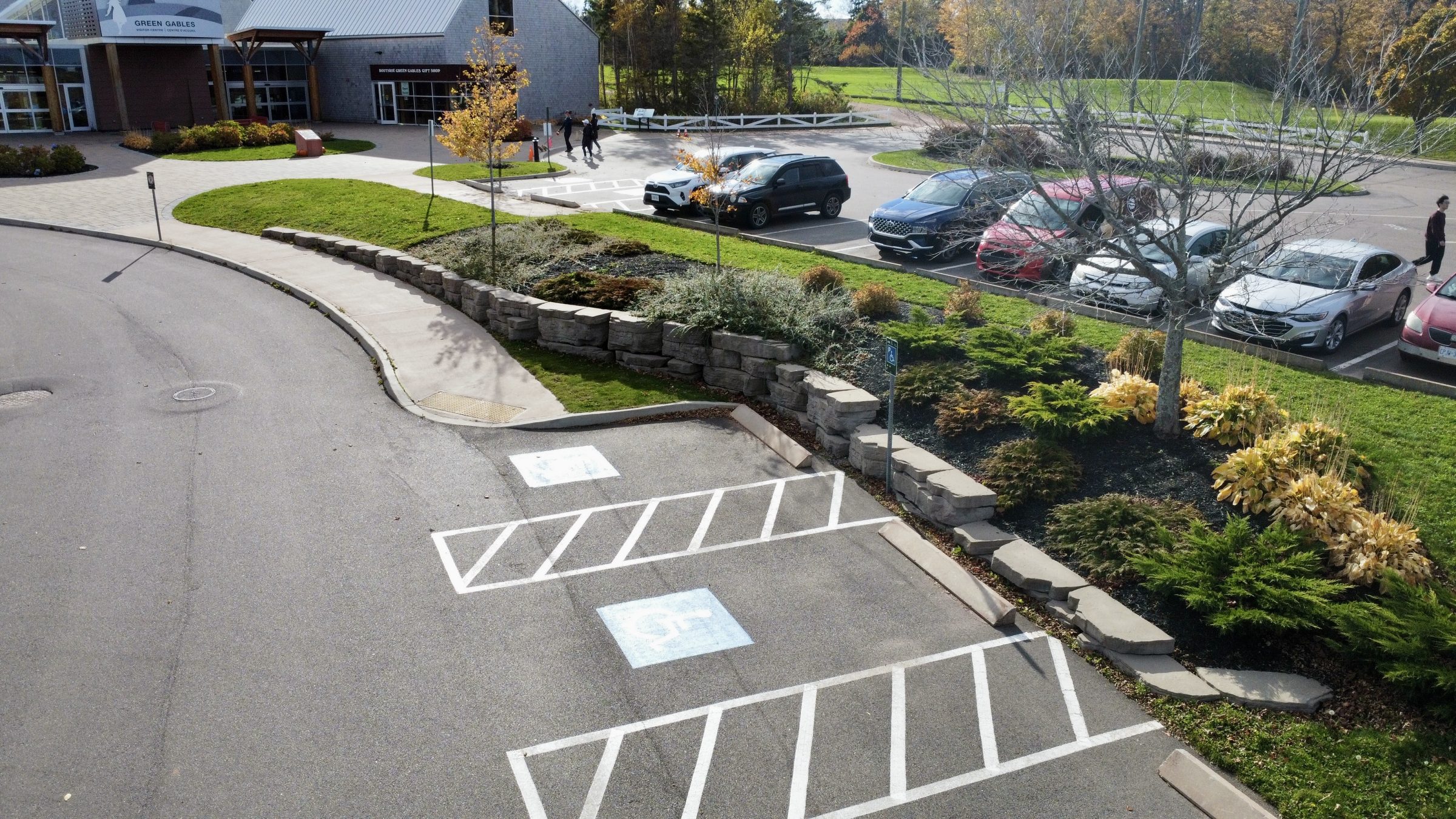 Accessible parking spaces near building entrance and gardens.