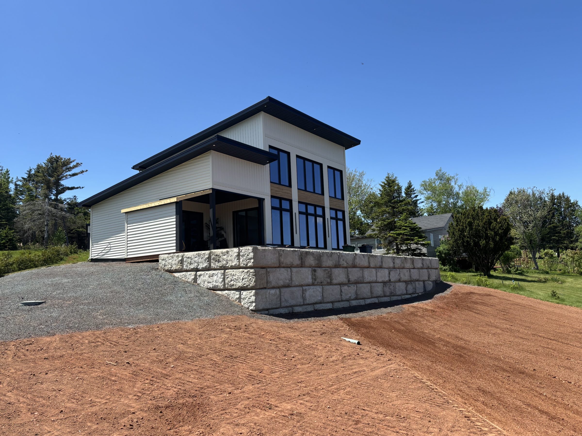 Modern house with large windows on sloped yard