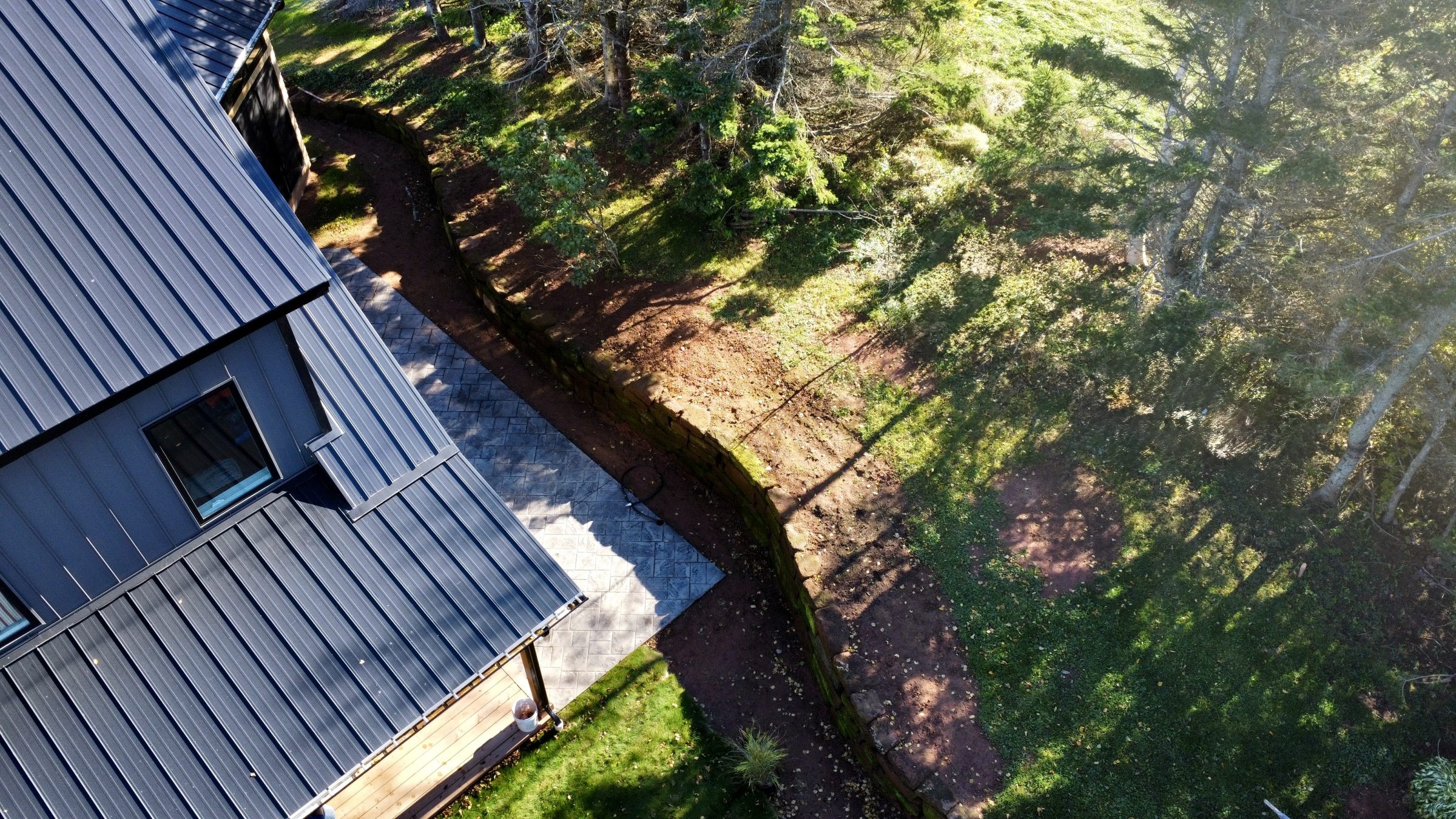 Aerial view of house and garden with stone path.