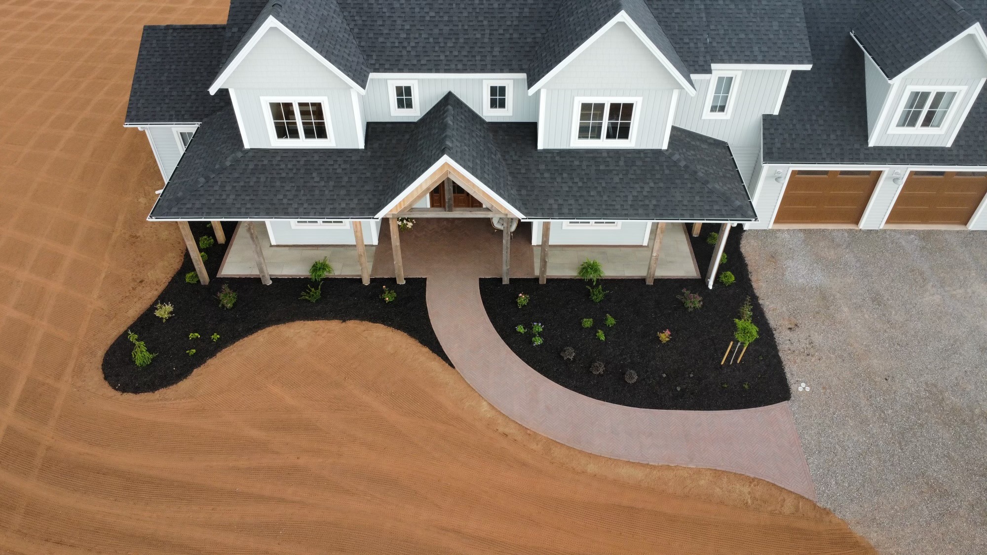 Aerial view of modern house with landscaped yard.