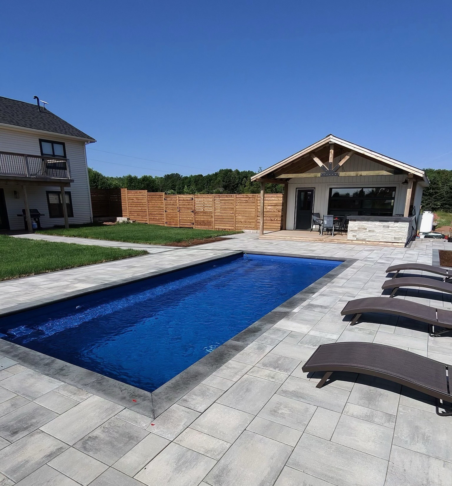 Backyard with pool and loungers