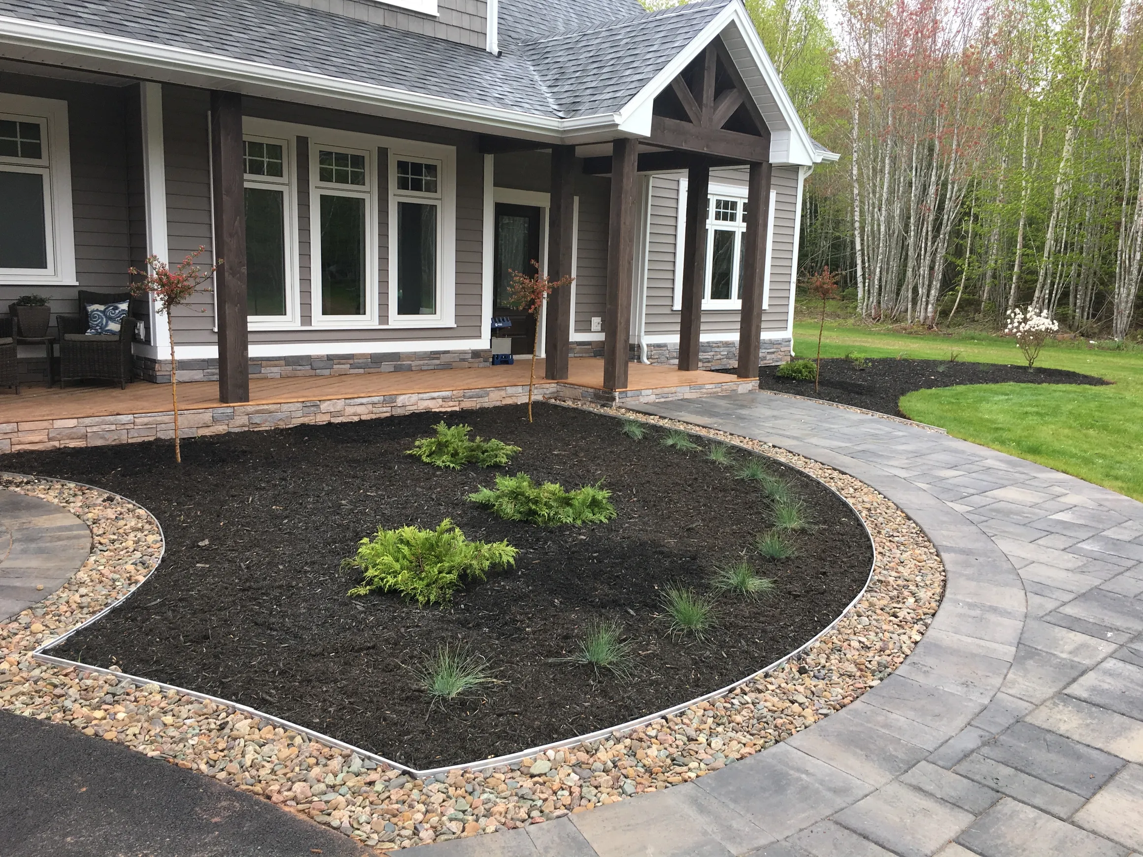 Modern house with landscaped garden and pathway.