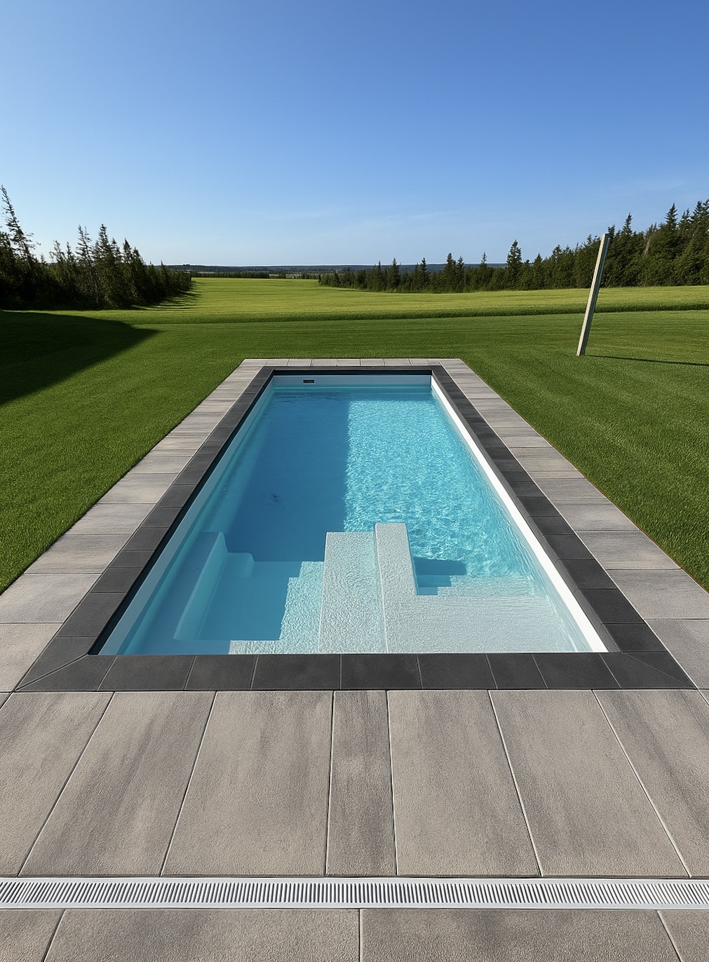 Rectangular pool with field and trees background.