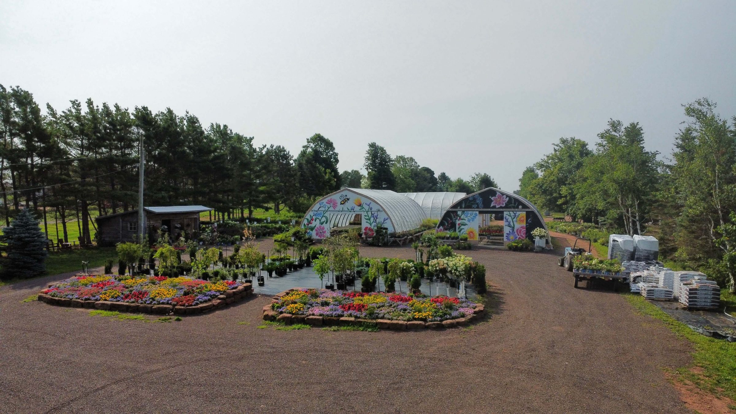 Colorful garden with greenhouses and flowers.