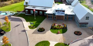 Aerial view of modern building with green lawn.