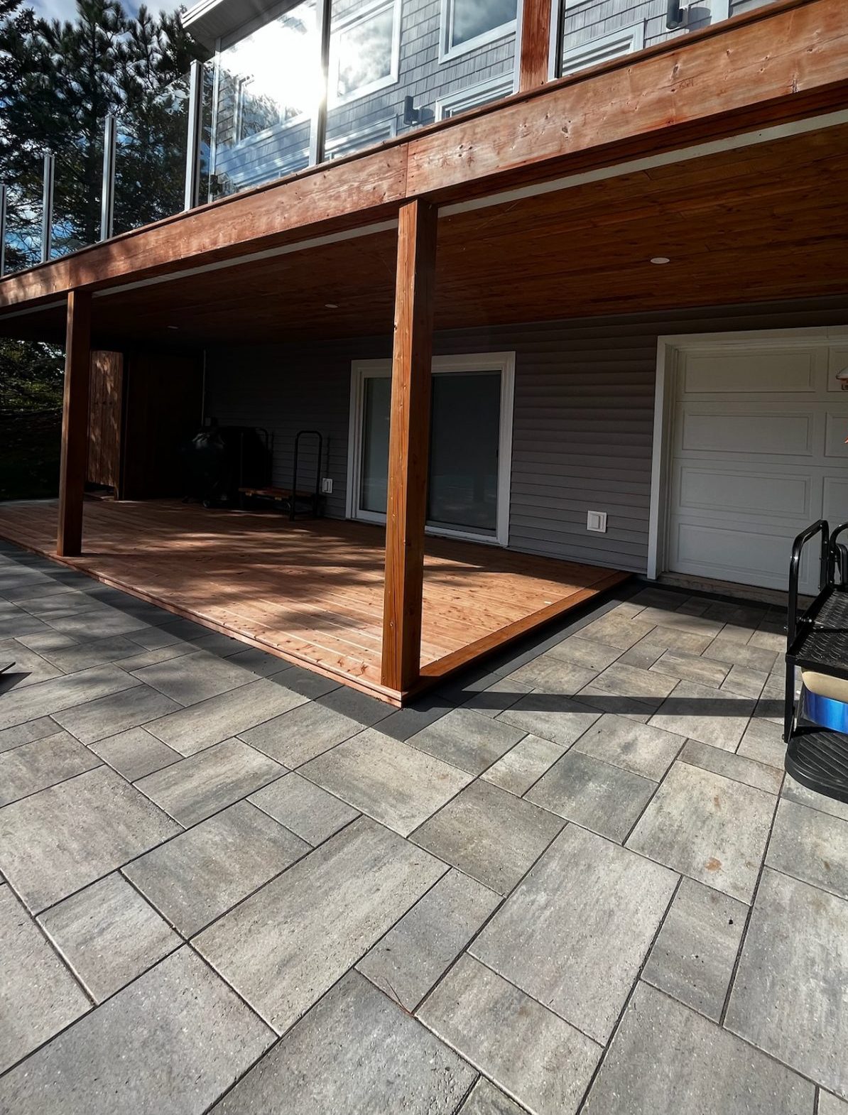 Newly built wooden deck with grey stone patio.