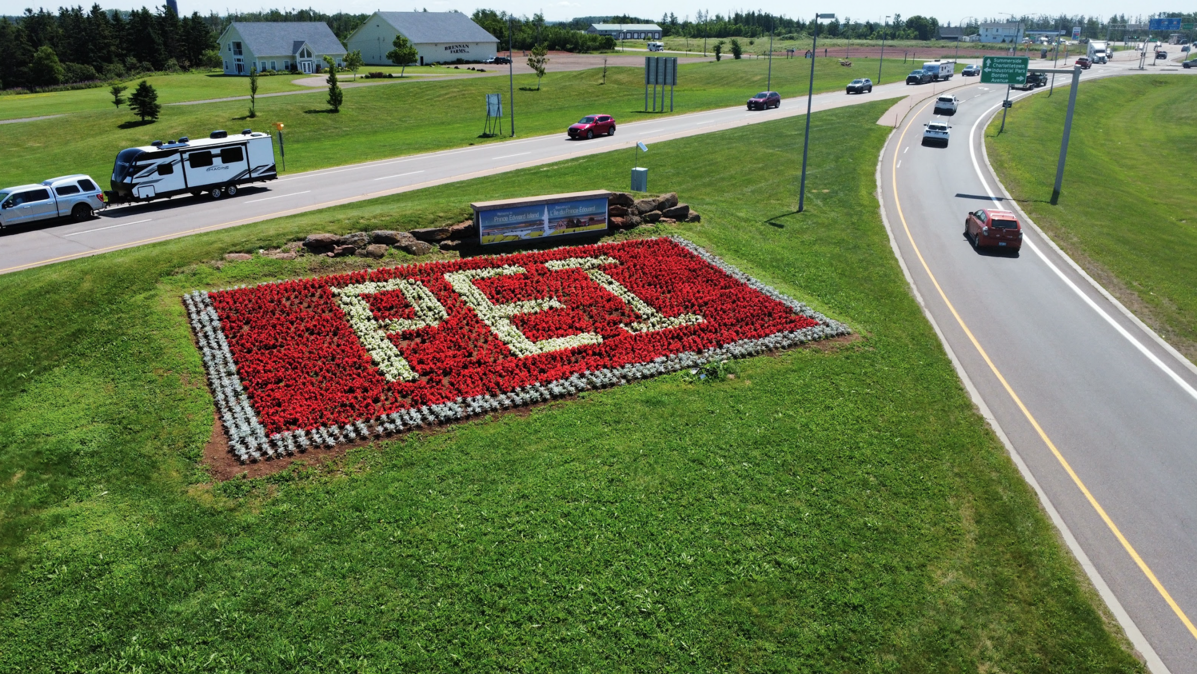 Flowerbed reading 'PEI' on highway median