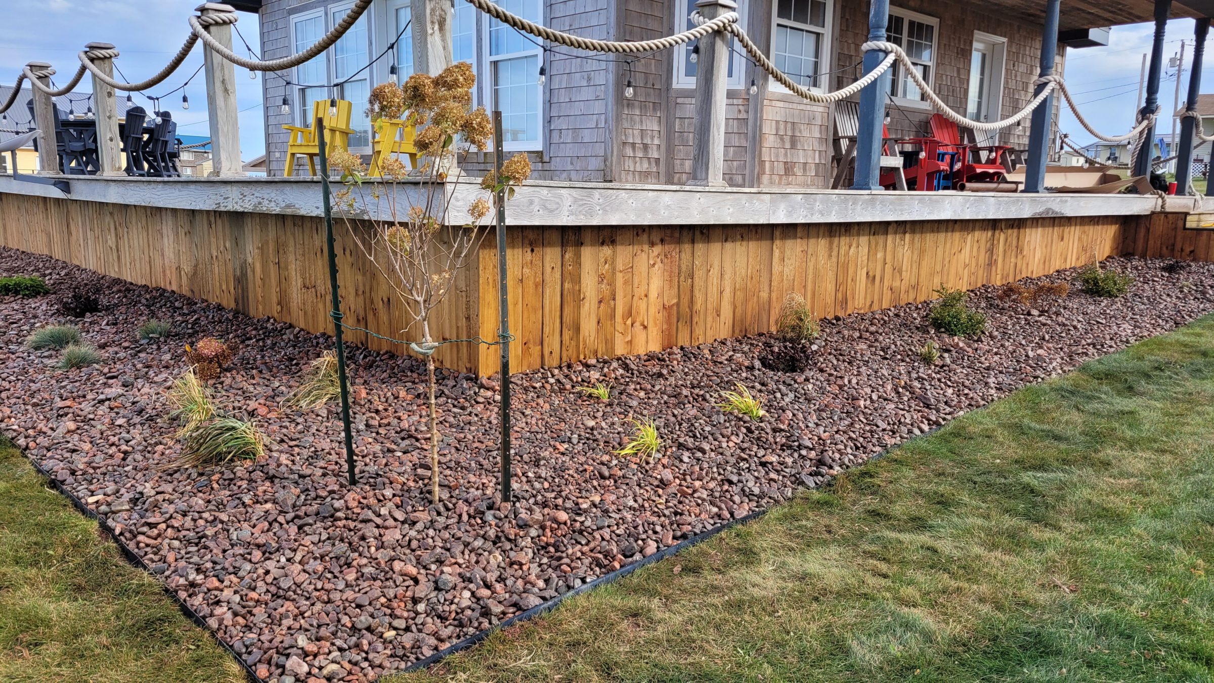 Wooden deck with rock garden and chairs